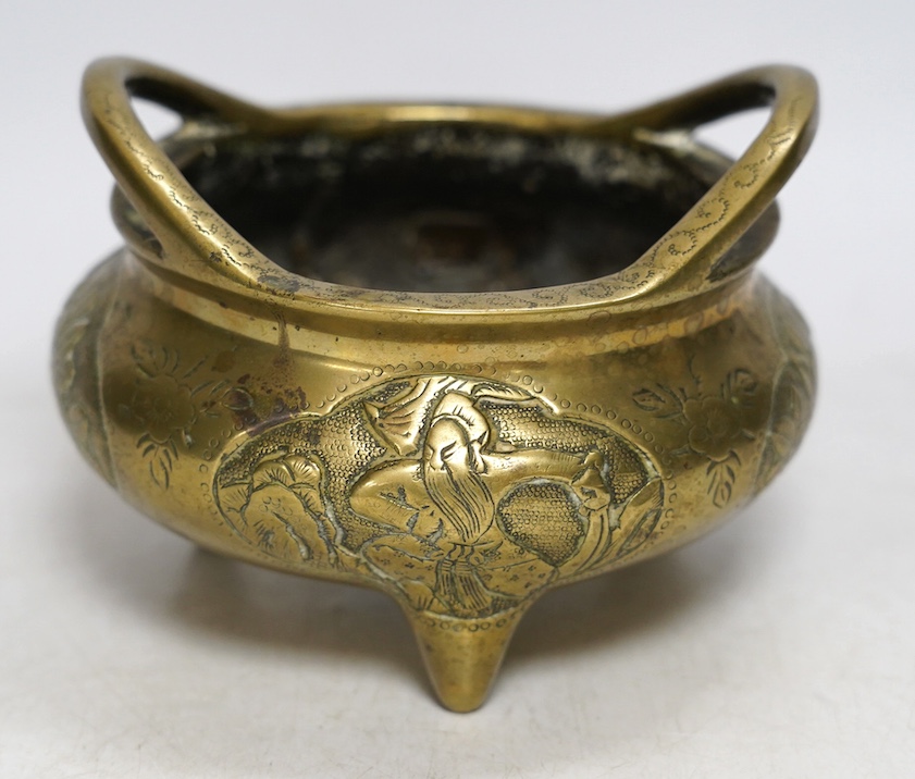 A Chinese bronze tripod censer, Xuande mark, 19th century, 13cm wide. Condition - plug repair to body